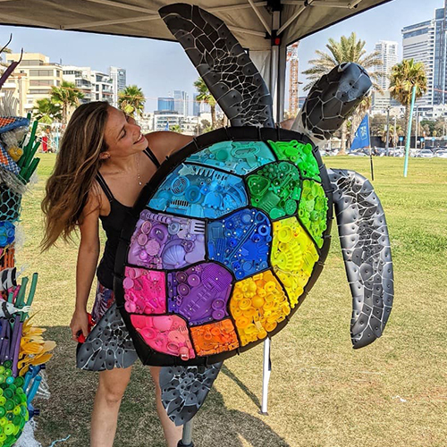 Women Leading Change: Evi Art Transforms Trash into Art to Speak about Environmental Issues