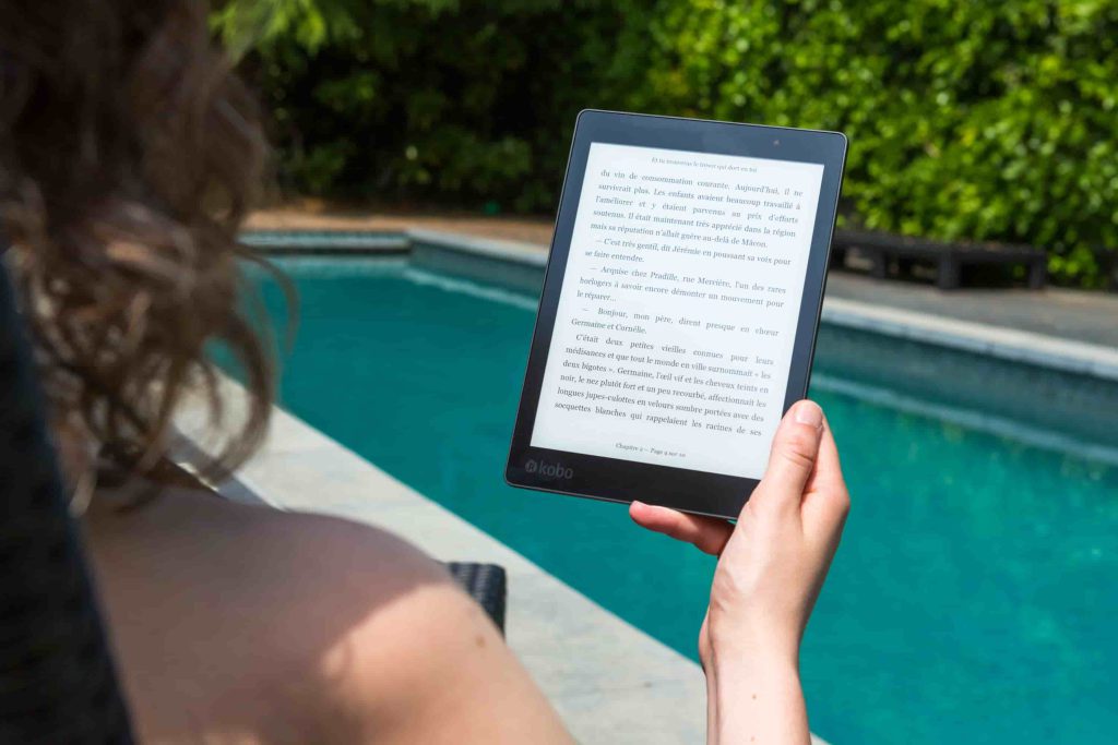 A photo of a women holding a tablet.