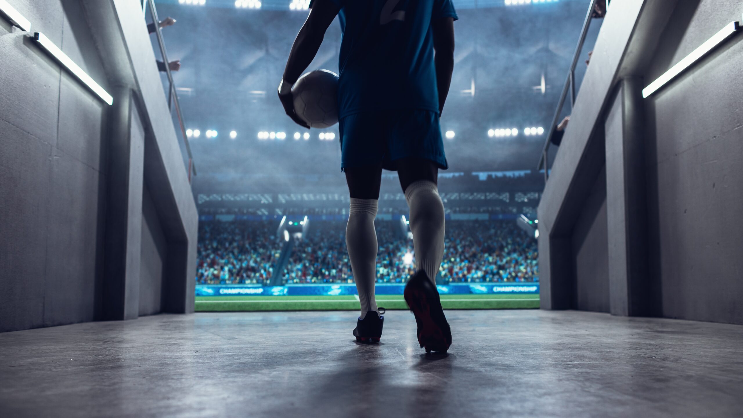 ロッカールームからフィールドに向かうサッカー選手